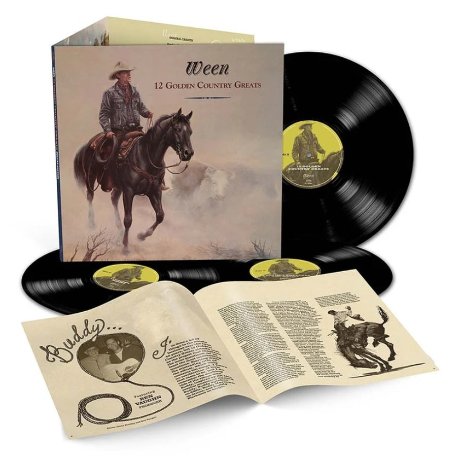 Vinyl record album set for 'Ween - 12 Golden Country Greats' with the illustrated album cover standing upright, two black LP records behind it, an open printed booklet spread out in front, and a second booklet or insert leaning against the cover. The cover art shows a cowboy riding a dark horse, and the records have yellow labels.